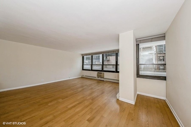 33 E Cedar St Unit 3D, Chicago, IL 60611 - empty room featuring light wood-type flooring and a baseboard radiator