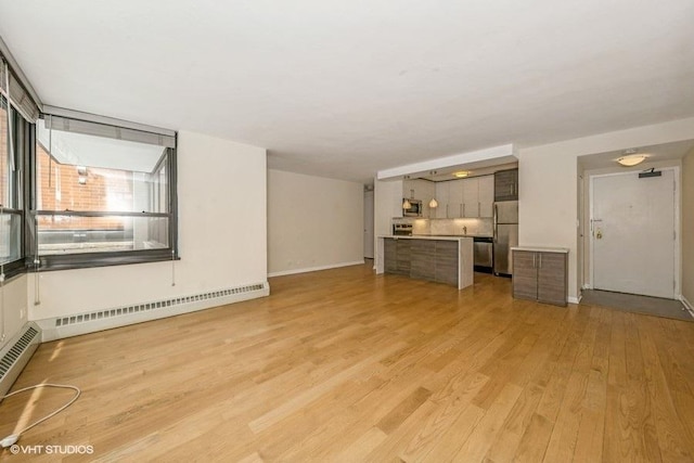 33 E Cedar St Unit 3D, Chicago, IL 60611 - unfurnished living room featuring light wood finished floors and a baseboard radiator