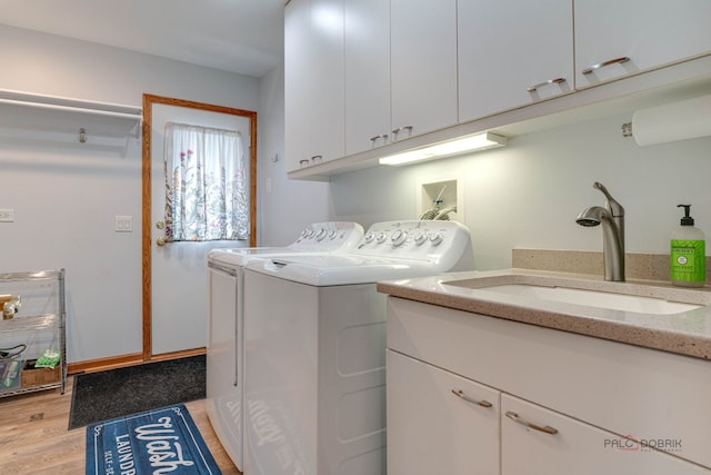908 Jackson Ave, Wauconda, IL 60084 - laundry room featuring separate washer and dryer, cabinet space, and light wood-type flooring