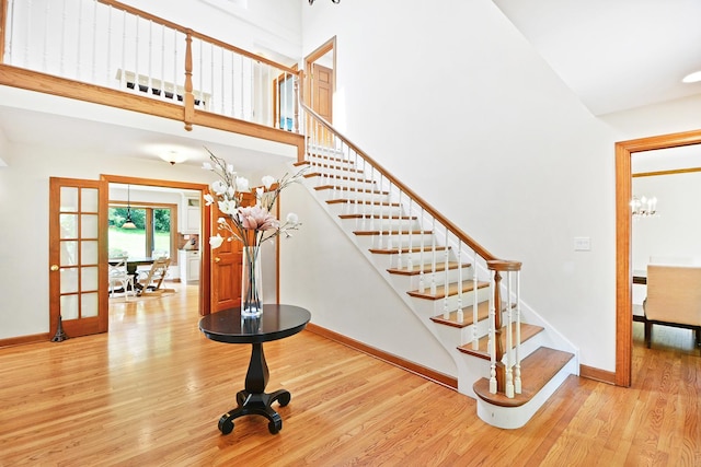24 Robin Crest Rd, Hawthorn Woods, IL 60047 - stairway featuring wood finished floors, a chandelier, a high ceiling, and french doors