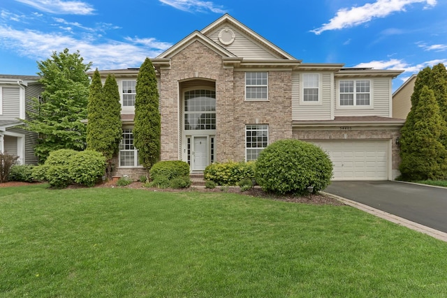 34405 N Bobolink Trl, Grayslake, IL 60030 - view of front of property with driveway, a front lawn, a garage, roof mounted solar panels, and brick siding