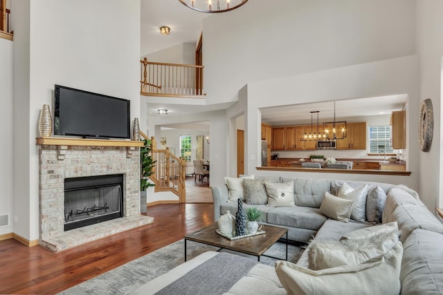 34405 N Bobolink Trl, Grayslake, IL 60030 - living room featuring a chandelier, wood finished floors, stairs, and a towering ceiling
