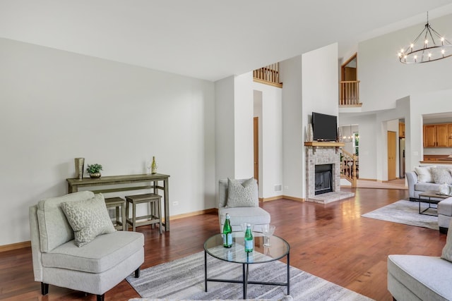 34405 N Bobolink Trl, Grayslake, IL 60030 - living area with a chandelier, a fireplace with raised hearth, wood finished floors, and a high ceiling