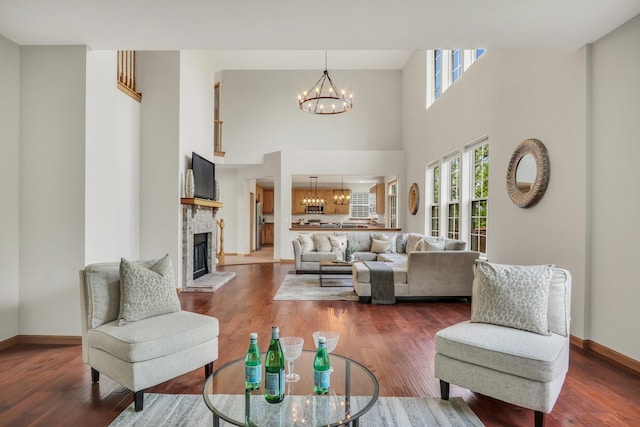 34405 N Bobolink Trl, Grayslake, IL 60030 - living room with a chandelier, a fireplace, wood finished floors, and a towering ceiling