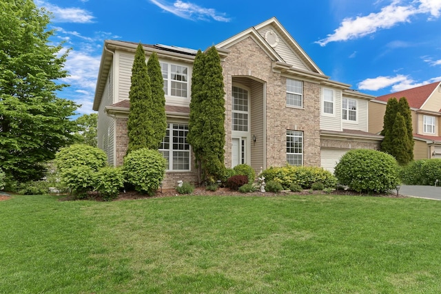 34405 N Bobolink Trl, Grayslake, IL 60030 - traditional-style house with a front yard, a garage, and brick siding
