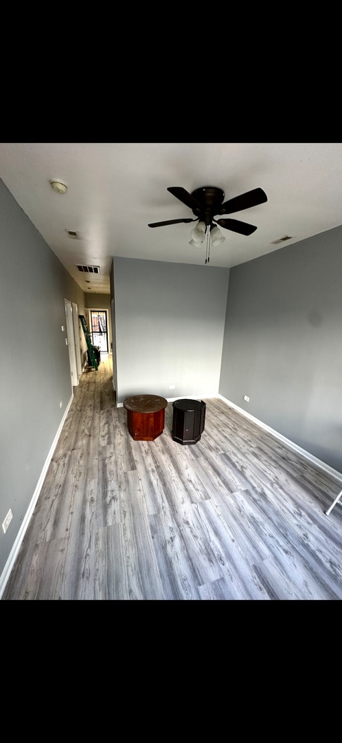 4226 W Ogden, Chicago, IL 60623 - unfurnished living room featuring wood finished floors and ceiling fan
