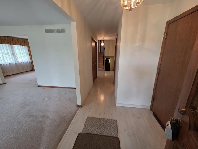 7725 Sawyer Rd, Darien, IL 60561 - hall with light wood-type flooring and a chandelier