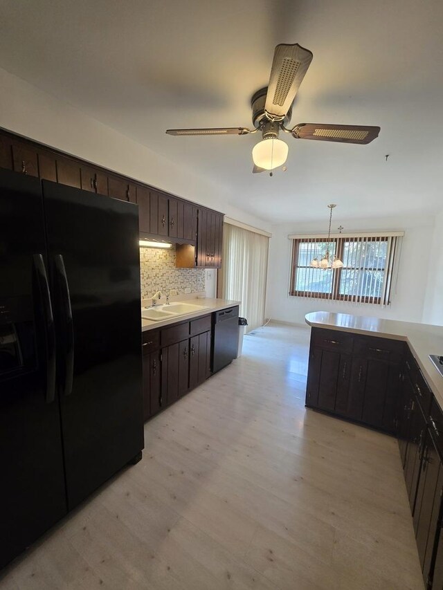 7725 Sawyer Rd, Darien, IL 60561 - kitchen with freestanding refrigerator, dishwashing machine, light wood finished floors, dark brown cabinetry, and a chandelier