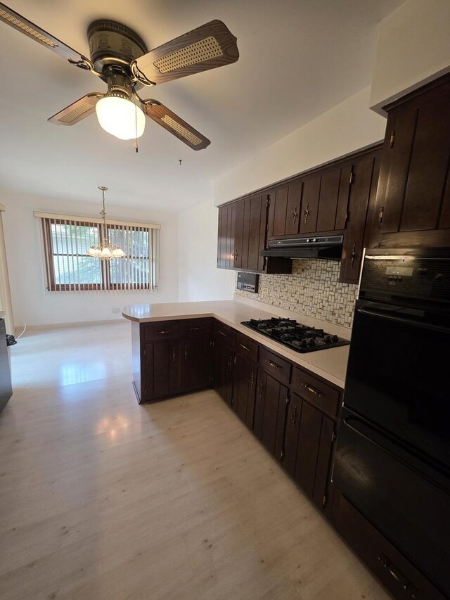 7725 Sawyer Rd, Darien, IL 60561 - kitchen featuring black appliances, under cabinet range hood, backsplash, light countertops, and light wood finished floors