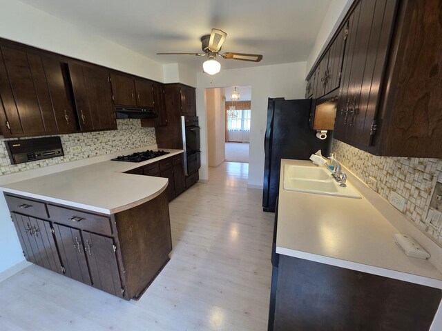 7725 Sawyer Rd, Darien, IL 60561 - kitchen featuring under cabinet range hood, dark brown cabinets, a ceiling fan, decorative backsplash, and light countertops