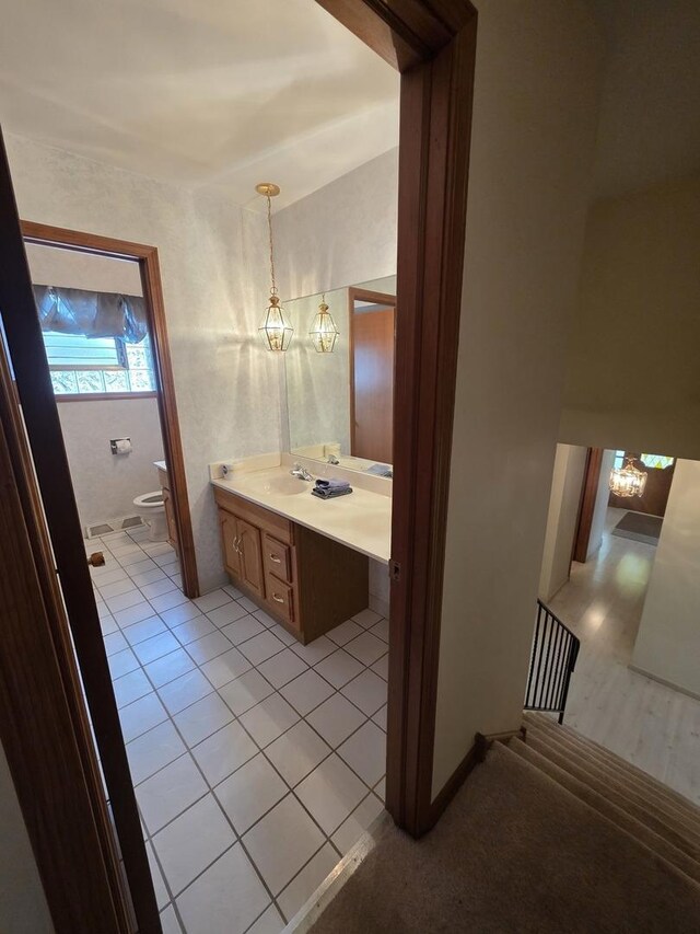 7725 Sawyer Rd, Darien, IL 60561 - half bathroom featuring vanity, tile patterned floors, and a chandelier