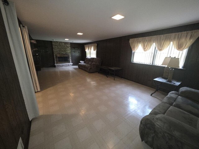 7725 Sawyer Rd, Darien, IL 60561 - living room featuring tile patterned floors, a fireplace, and wooden walls