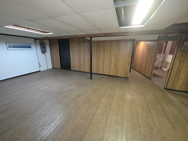 7725 Sawyer Rd, Darien, IL 60561 - finished basement with light wood-type flooring, wooden walls, and a paneled ceiling