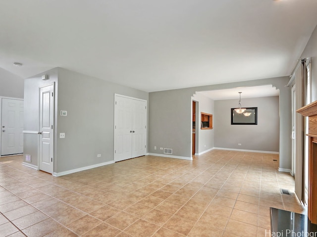 690 Savannah Ln, Crystal Lake, IL 60014 - unfurnished room with light tile patterned floors and a chandelier