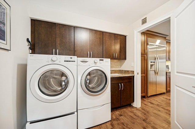 1740 Mission Hills Rd Unit 304, Northbrook, IL 60062 - laundry area featuring cabinet space, washer and clothes dryer, and wood finished floors