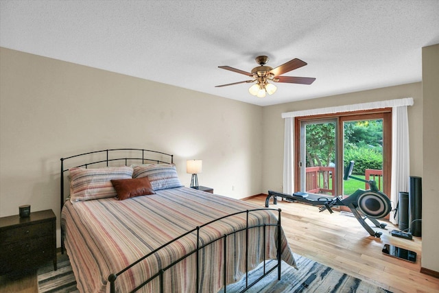 3204 Fawn Hill Ct, Urbana, IL 61802 - bedroom with wood finished floors, access to exterior, a textured ceiling, and a ceiling fan