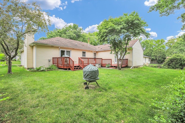 3204 Fawn Hill Ct, Urbana, IL 61802 - rear view of property featuring a lawn, a wooden deck, a chimney, a fire pit, and a shingled roof