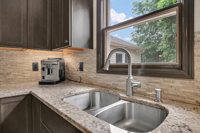 3204 Fawn Hill Ct, Urbana, IL 61802 - kitchen featuring decorative backsplash, dark brown cabinetry, and light stone countertops
