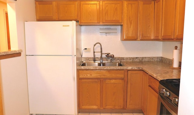 9740 S Pulaski Rd Unit 107, Oak Lawn, IL 60453 - kitchen featuring freestanding refrigerator, gas stove, backsplash, light countertops, and brown cabinets