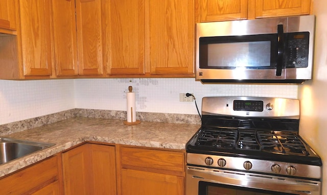 9740 S Pulaski Rd Unit 107, Oak Lawn, IL 60453 - kitchen featuring appliances with stainless steel finishes and decorative backsplash