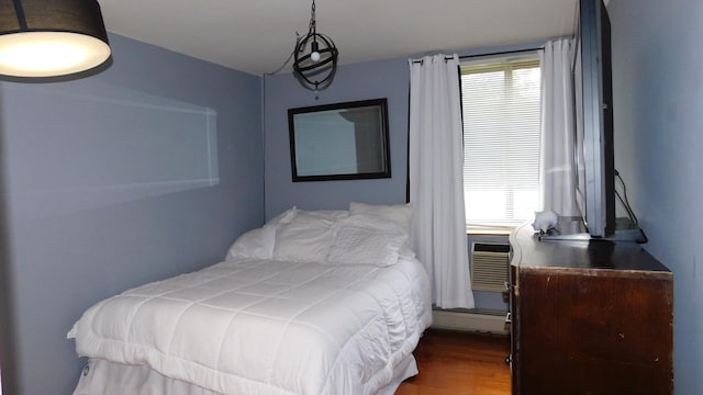 9740 S Pulaski Rd Unit 107, Oak Lawn, IL 60453 - bedroom featuring multiple windows, a baseboard heating unit, wood finished floors, and a wall mounted AC
