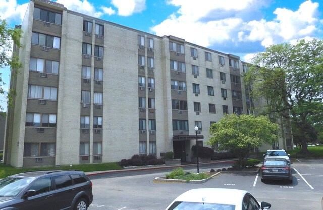 9740 S Pulaski Rd Unit 107, Oak Lawn, IL 60453 - view of apartment building / complex featuring uncovered parking