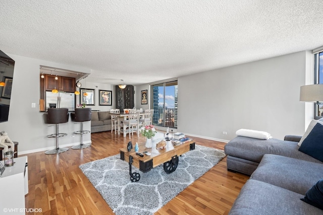 70 W Huron St Unit 2202, Chicago, IL 60654 - living room featuring a textured ceiling, healthy amount of natural light, and wood finished floors