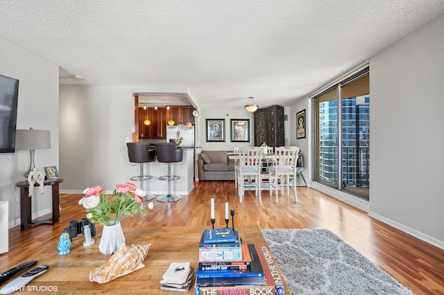 70 W Huron St Unit 2202, Chicago, IL 60654 - living room featuring wood finished floors and a textured ceiling