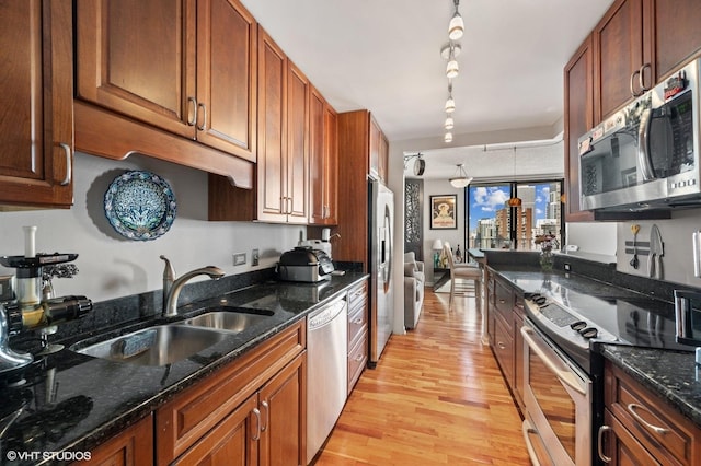 70 W Huron St Unit 2202, Chicago, IL 60654 - kitchen with appliances with stainless steel finishes, light wood finished floors, track lighting, and dark stone counters