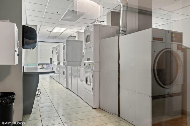 70 W Huron St Unit 2202, Chicago, IL 60654 - shared laundry room with stacked washer and clothes dryer, light tile patterned flooring, and washing machine and dryer