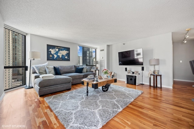 70 W Huron St Unit 2202, Chicago, IL 60654 - living room with light wood-type flooring, a textured ceiling, plenty of natural light, and floor to ceiling windows