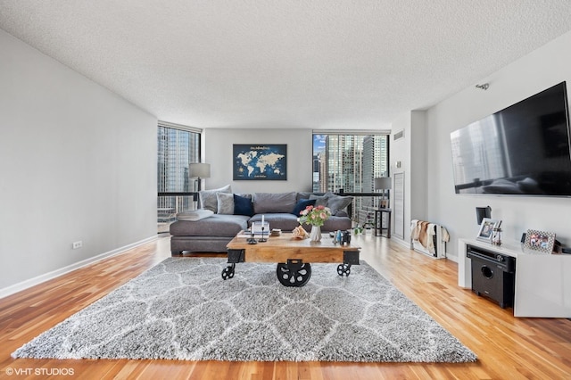 70 W Huron St Unit 2202, Chicago, IL 60654 - living room featuring a textured ceiling, light wood-style flooring, and expansive windows