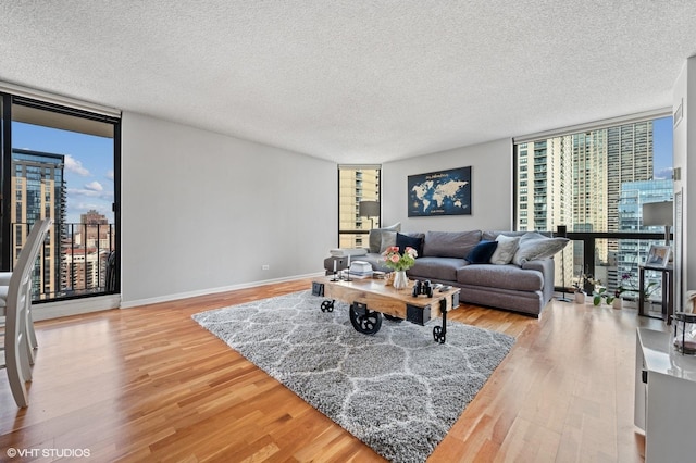 70 W Huron St Unit 2202, Chicago, IL 60654 - living area with a wall of windows, wood finished floors, a city view, and a textured ceiling