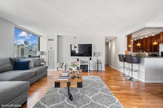 70 W Huron St Unit 2202, Chicago, IL 60654 - living area featuring light wood-style floors, a textured ceiling, and rail lighting