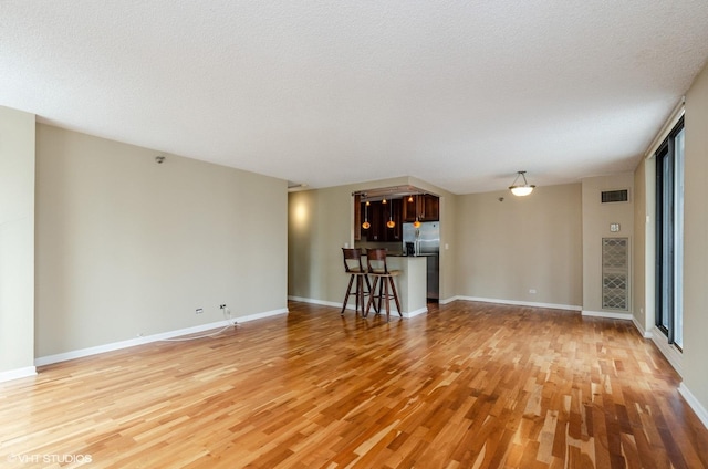70 W Huron St Unit 2202, Chicago, IL 60654 - unfurnished living room with light wood finished floors and a textured ceiling