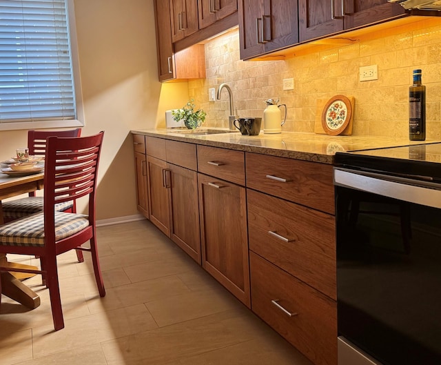 825 Pearson St Unit 3A, Des Plaines, IL 60016 - kitchen featuring stainless steel electric stove, backsplash, light stone countertops, and brown cabinetry