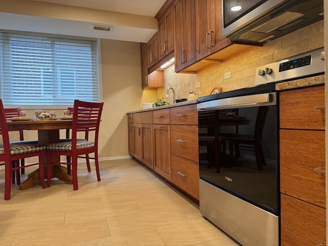 825 Pearson St Unit 3A, Des Plaines, IL 60016 - kitchen with appliances with stainless steel finishes, tasteful backsplash, and brown cabinets