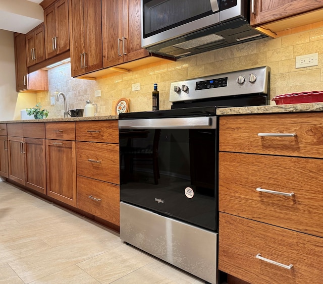825 Pearson St Unit 3A, Des Plaines, IL 60016 - kitchen featuring appliances with stainless steel finishes and brown cabinets