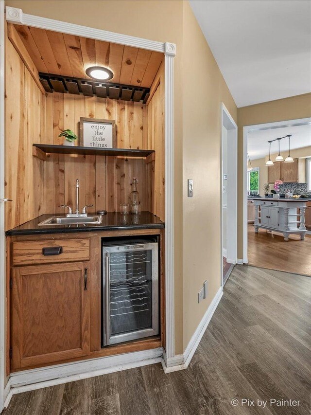 200 Ambria Dr, Mundelein, IL 60060 - indoor wet bar with beverage cooler, dark wood-style flooring, wood ceiling, and wooden walls