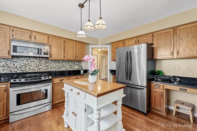 200 Ambria Dr, Mundelein, IL 60060 - kitchen with stainless steel appliances, open shelves, tasteful backsplash, and light wood-style floors