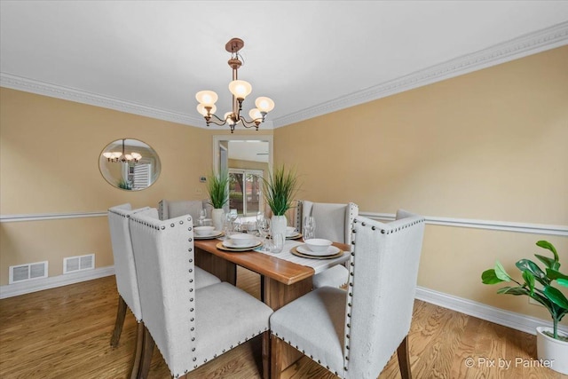200 Ambria Dr, Mundelein, IL 60060 - dining space with a chandelier, wood finished floors, and ornamental molding