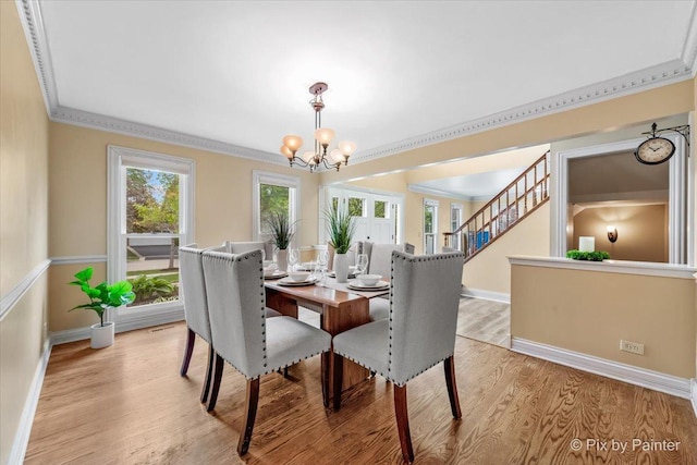 200 Ambria Dr, Mundelein, IL 60060 - dining space featuring crown molding, a chandelier, light wood-style floors, and stairs