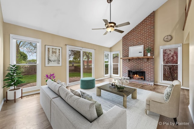 200 Ambria Dr, Mundelein, IL 60060 - living room with healthy amount of natural light, a brick fireplace, high vaulted ceiling, ceiling fan, and wood finished floors