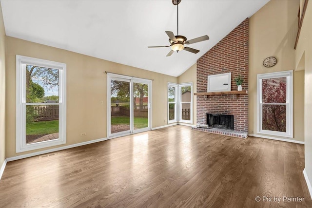 200 Ambria Dr, Mundelein, IL 60060 - unfurnished living room with healthy amount of natural light, a ceiling fan, high vaulted ceiling, and wood finished floors