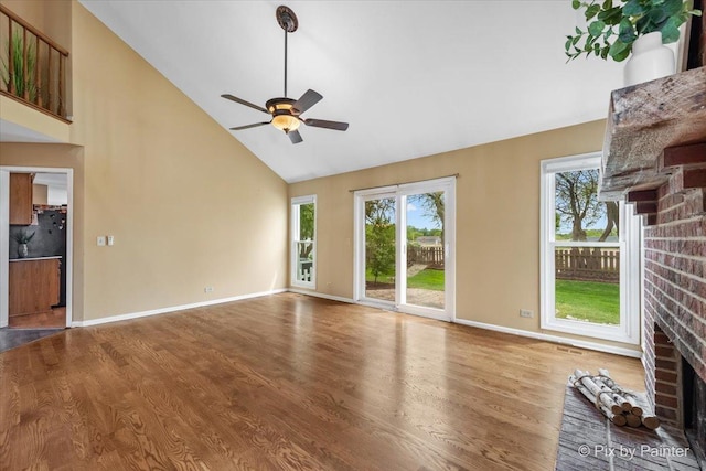 200 Ambria Dr, Mundelein, IL 60060 - unfurnished living room featuring a fireplace, high vaulted ceiling, ceiling fan, healthy amount of natural light, and wood finished floors