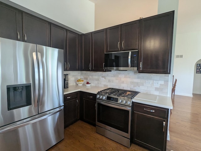 1471 Baroque Ave, Volo, IL 60073 - kitchen featuring appliances with stainless steel finishes, light countertops, dark wood finished floors, and backsplash