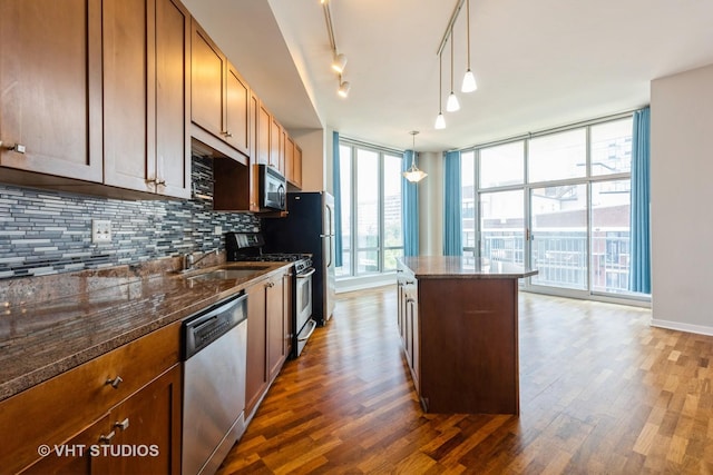 1600 S Indiana Ave Unit 508, Chicago, IL 60616 - kitchen featuring stainless steel appliances, a kitchen island, backsplash, and dark wood-style floors