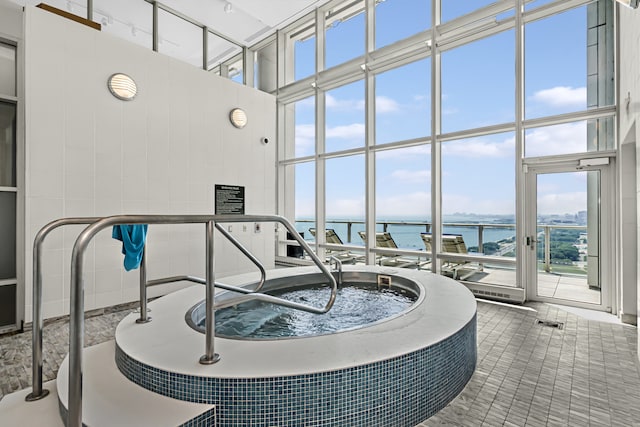 340 E Randolph St Unit 404, Chicago, IL 60601 - interior space with a water view, healthy amount of natural light, a towering ceiling, and floor to ceiling windows