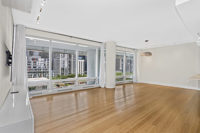 340 E Randolph St Unit 404, Chicago, IL 60601 - empty room featuring rail lighting and light wood-style flooring