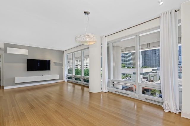 340 E Randolph St Unit 404, Chicago, IL 60601 - unfurnished living room with wood finished floors and healthy amount of natural light